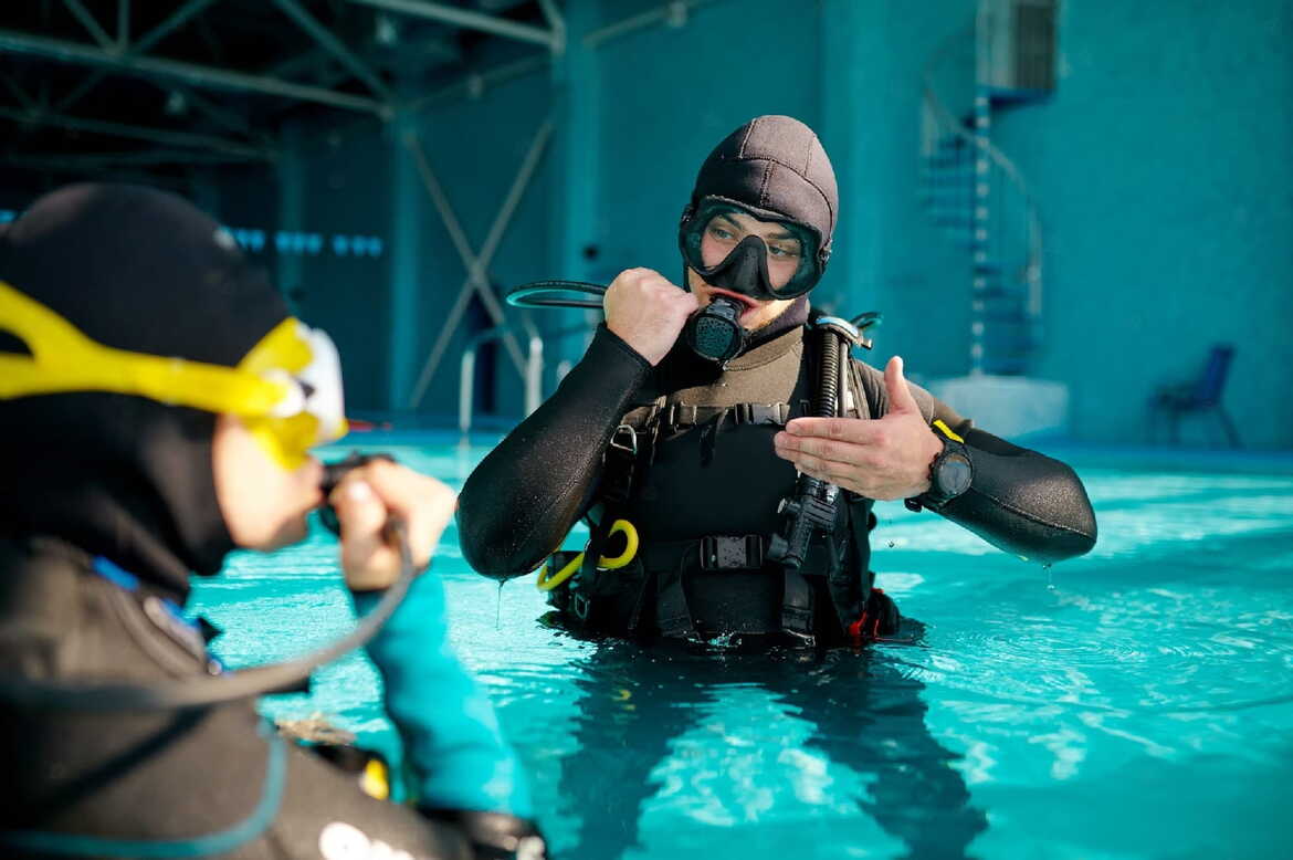 A scuba diver swimming in the clear waters of Saranda, Albania during their Padi Dive Master Course